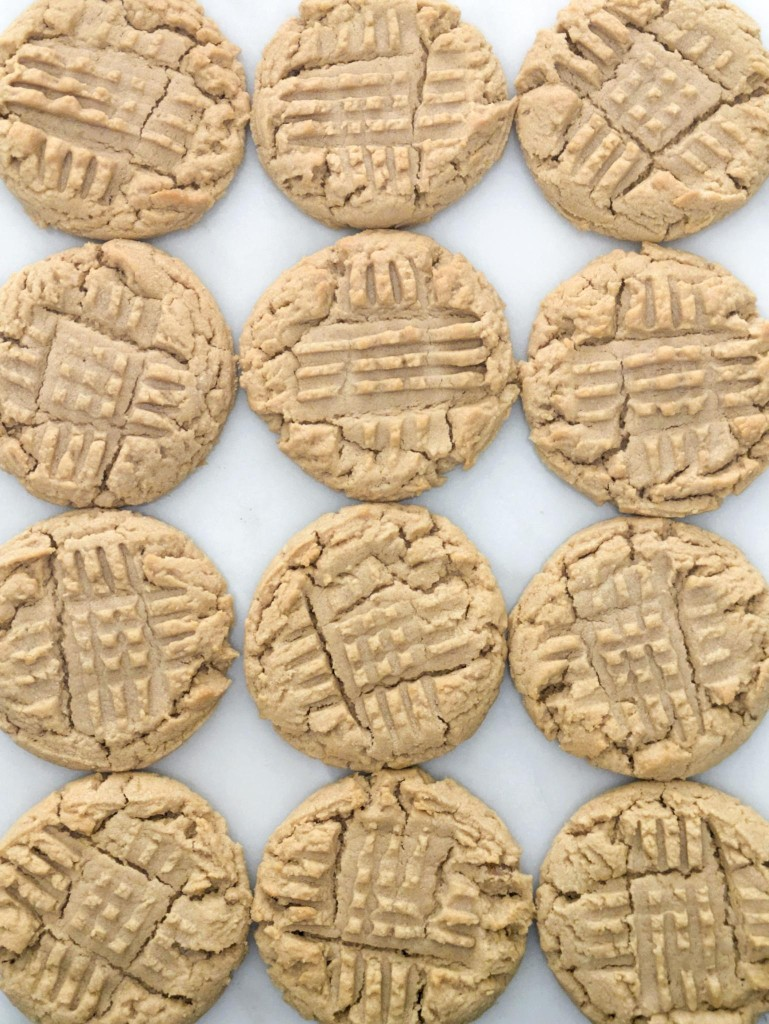A dozen peanut butter cookies on marble